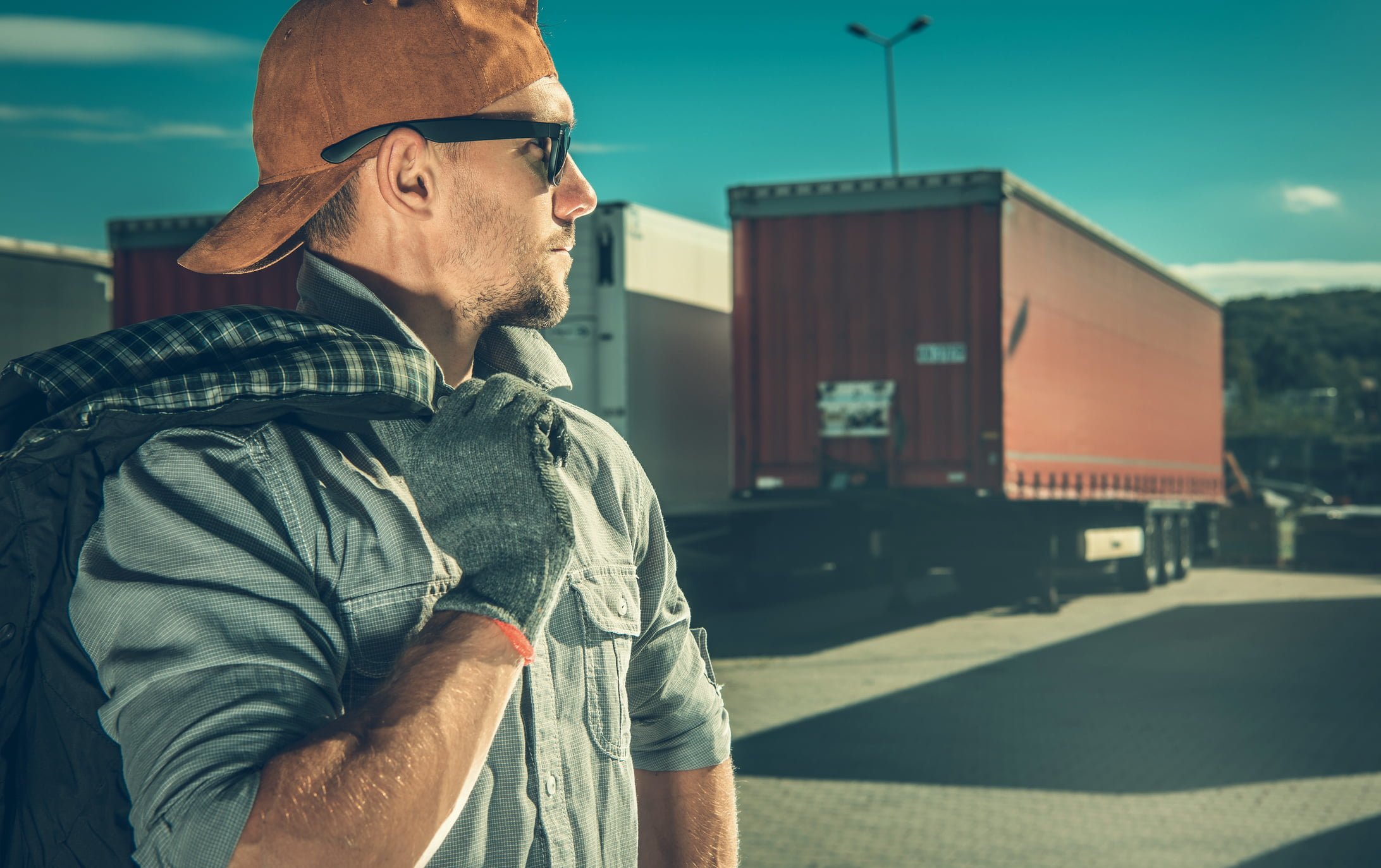 Professional Truck Driver CDL Driver standing in front of 18-wheeler