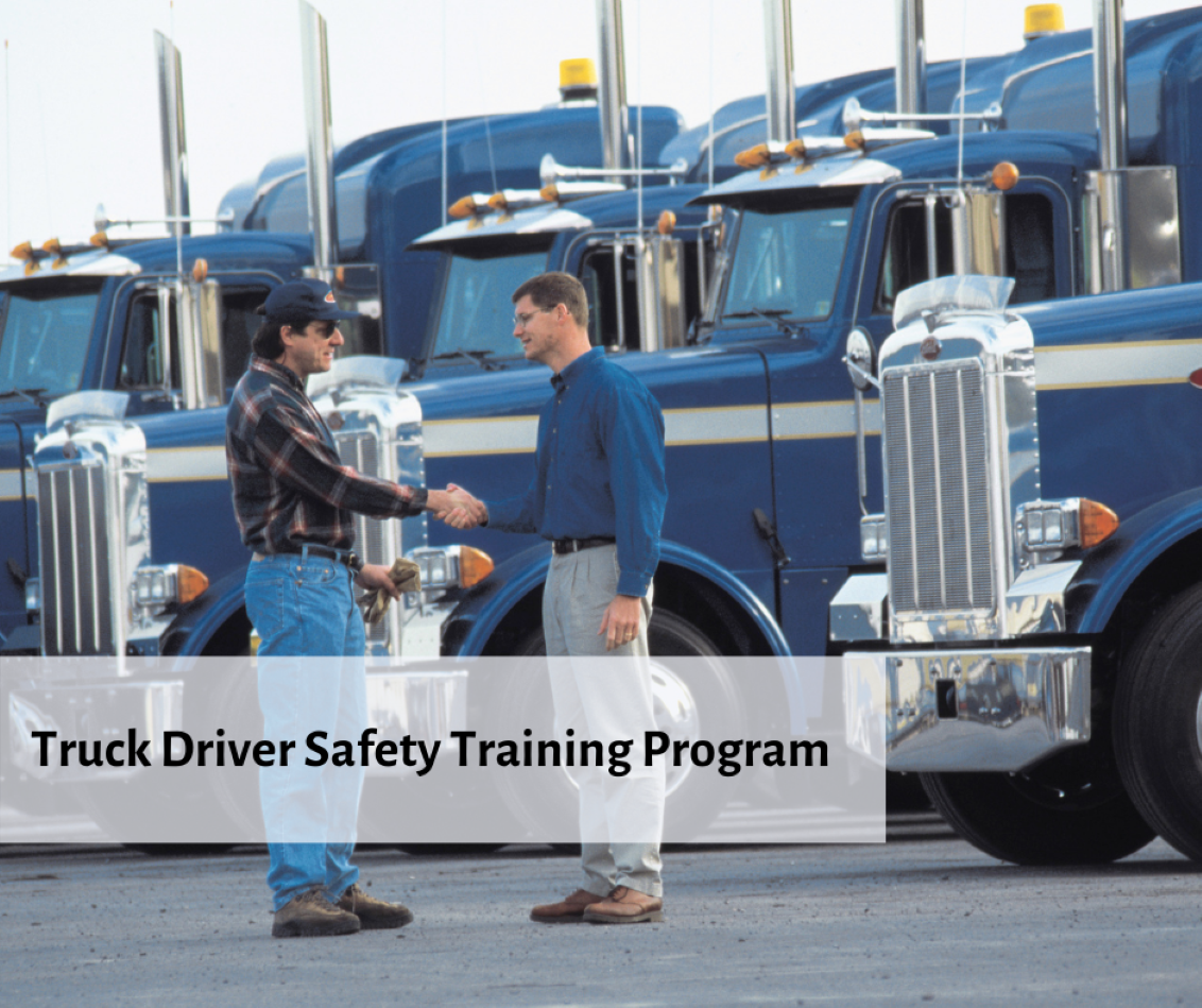 Two men shaking hands by semi trucks