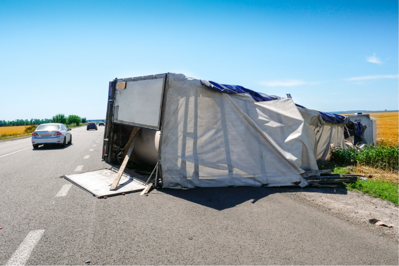 Semi truck tipped over.