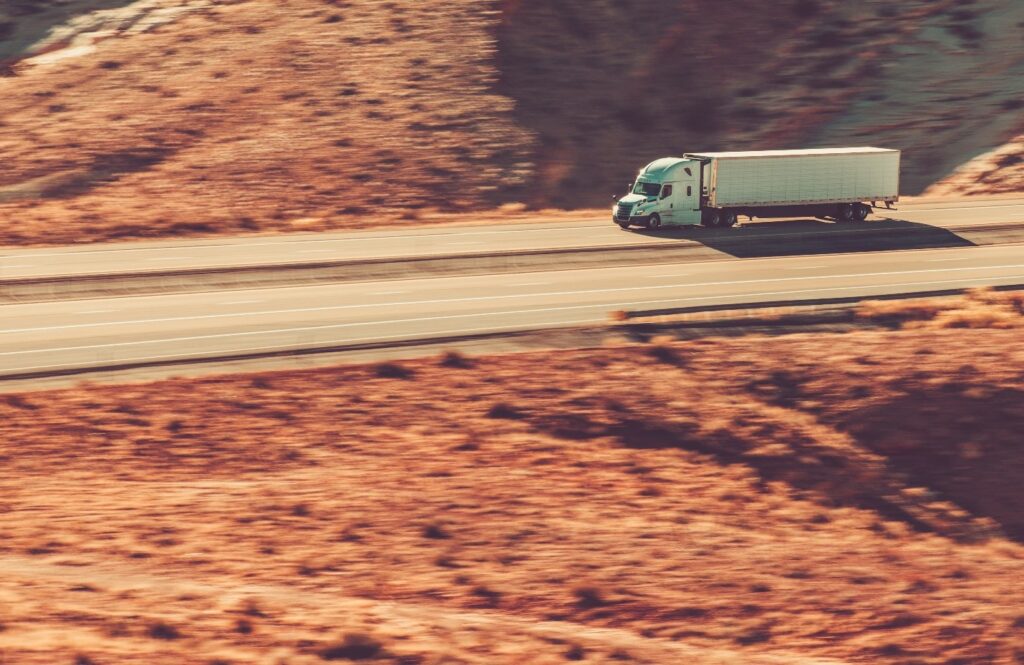 Semi driving on desert road