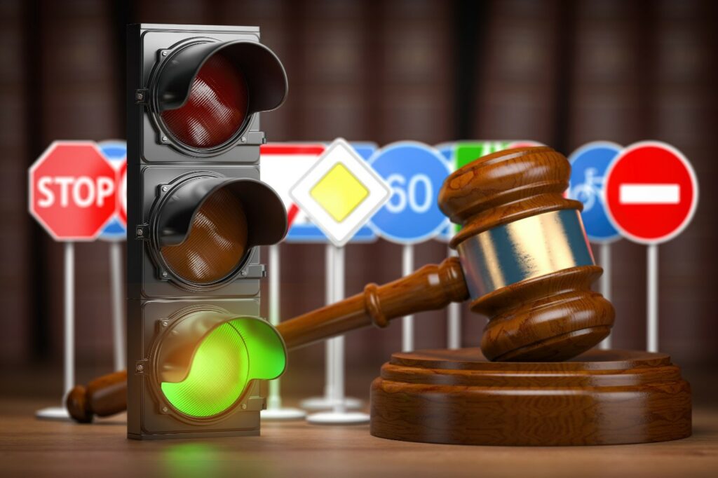 traffic signs and stoplight on a desk with a gavel